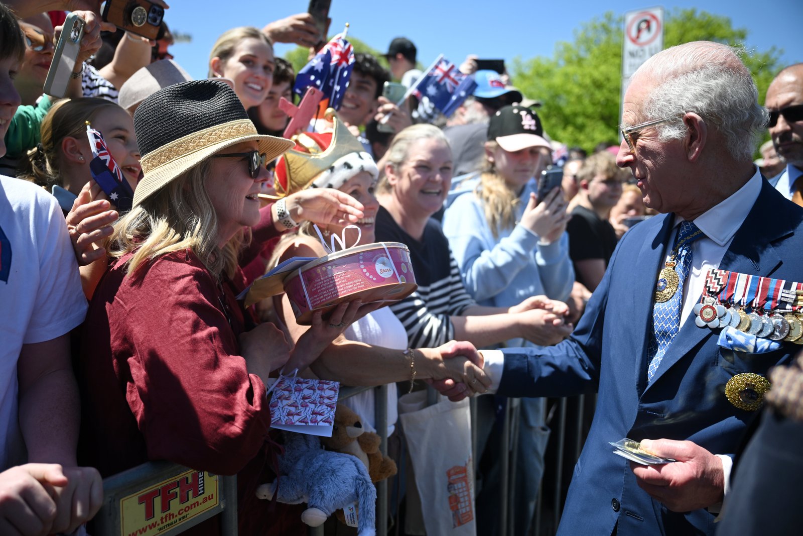 Some of the well-wishers in the crowds outside the Australian War Memorial in Canberra brought gifts (Victoria Jones/PA)