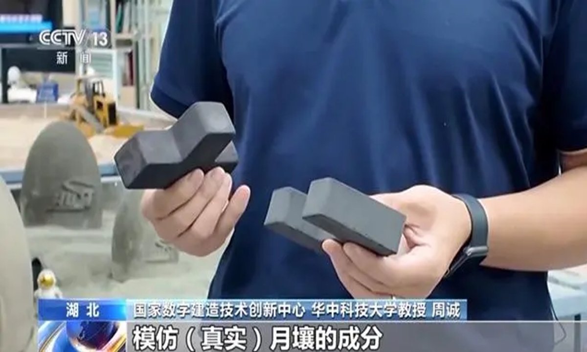 A researcher presents bricks made from simulated lunar soil, a potential building material for future habitats on the moon. The bricks have a density comparable to ordinary ones, but their compressive strength exceeds that of standard red bricks and concrete bricks by more than three times. Photo: CCTV