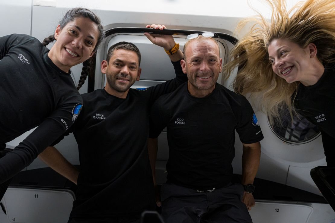 The Polaris Dawn crew poses in space, from left: Sarah Gillis, Jared Isaacman, Scott Poteet and Anna Menon.