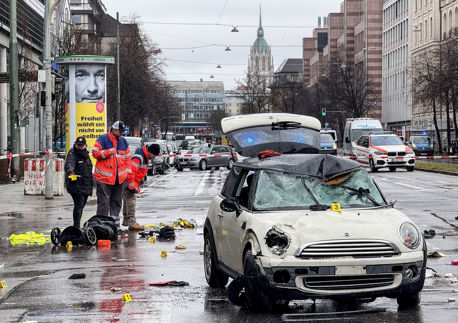 A damaged car is seen on stage after a vehicle was driven into a Verdi demonstration in Munich