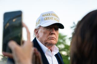 US President Donald Trump speaks to the press after arriving at the southern lawn of the White House in Washington, DC
