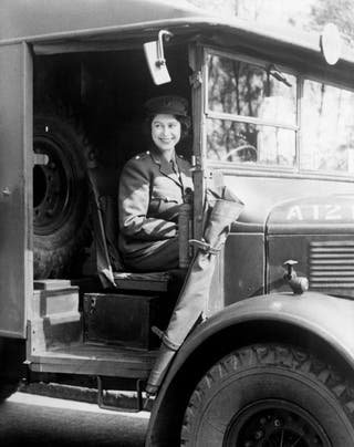 Princess Elizabeth by the wheel of an army vehicle when she served during World War II (Pa)