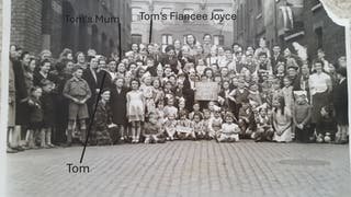 Veteran Thomas Cuthbert (in naval uniform, standing front, center on the left) next to his mother on a woe tea party (Collect/Blind Veteran's UK/PA)