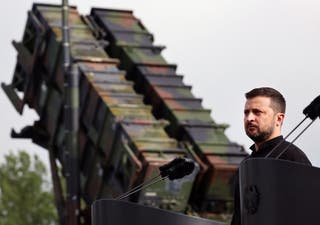 Volodymyr Zelensky stands in front of a Patriot Anti-Alcraft missile system during his visit to a military training area in Mecklenburg, Germany