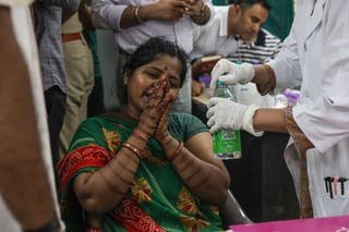 A relative of a victim who died in a plane crash is mourning when she arrives to give a DNA test to demand the body at Civil Hospital in Ahmedabad, Gujarat
