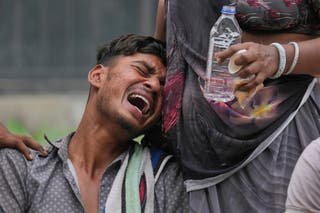 Kalpesh Bhai, whose 14-year-old brother was killed when an Air India aircraft crashed into a neighborhood, crying outside the autopsy space