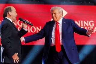 US President Donald Trump moves on stage as Lee Greenwood sings under a memorial for killed conservative commentator Charlie Kirk at State Farm Stadium, in Glendale, Arizona, USA, September 21, 2025