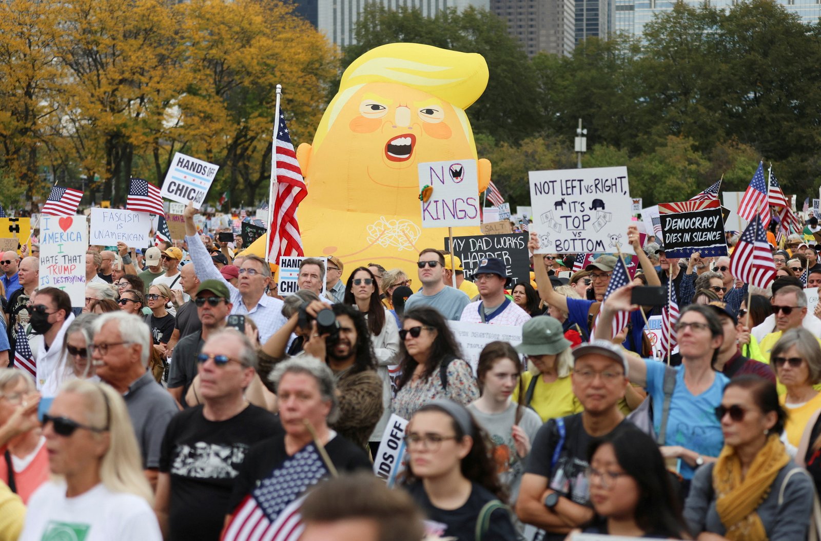 Protesters march alongside a massive balloon depicting Trump in Chicago