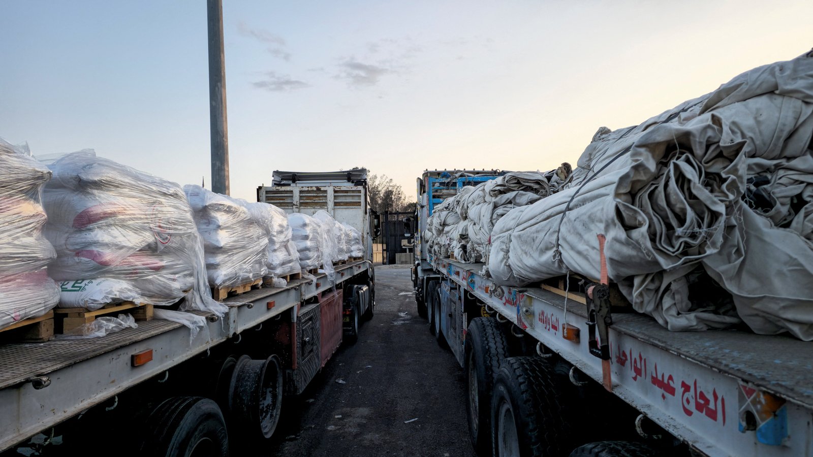 Trucks carrying humanitarian aid line up at the Gaza Strip crossing at the Rafah border on the Egyptian side